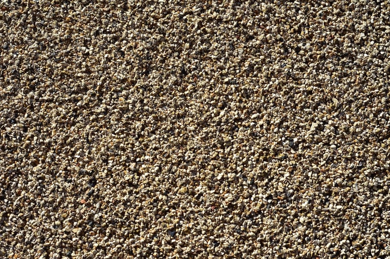 Pattern of fine gravel particles bonded together by resin